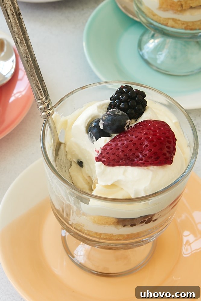 Individual Berry Cheesecake Trifles with layers of cake, cheesecake, and berries.