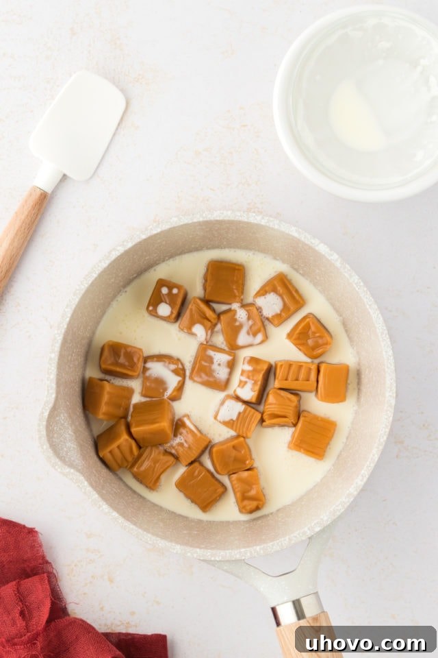 Overhead view of caramels and heavy cream in pan