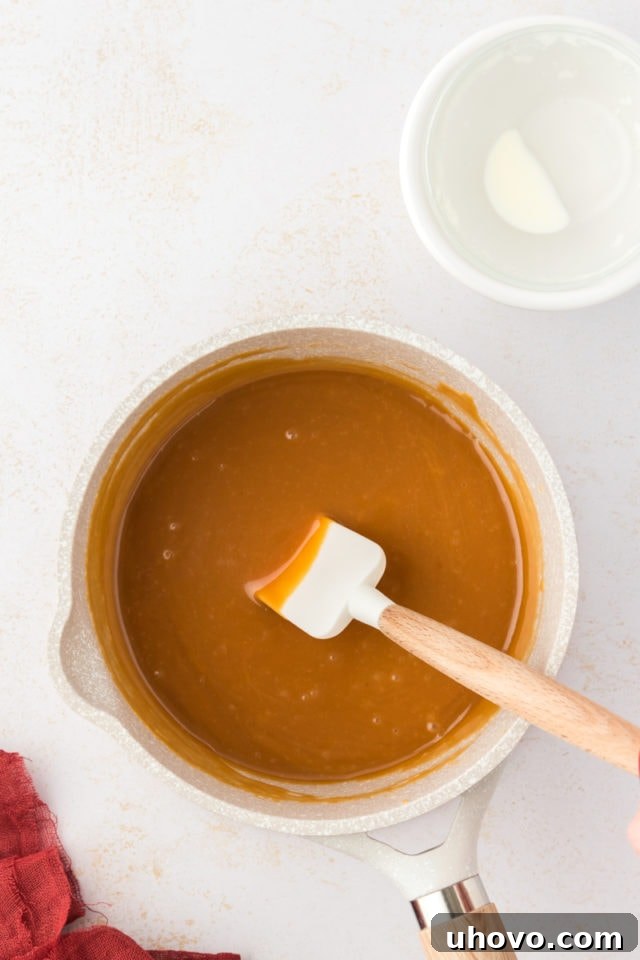 Overhead view of caramel in pan with spatula