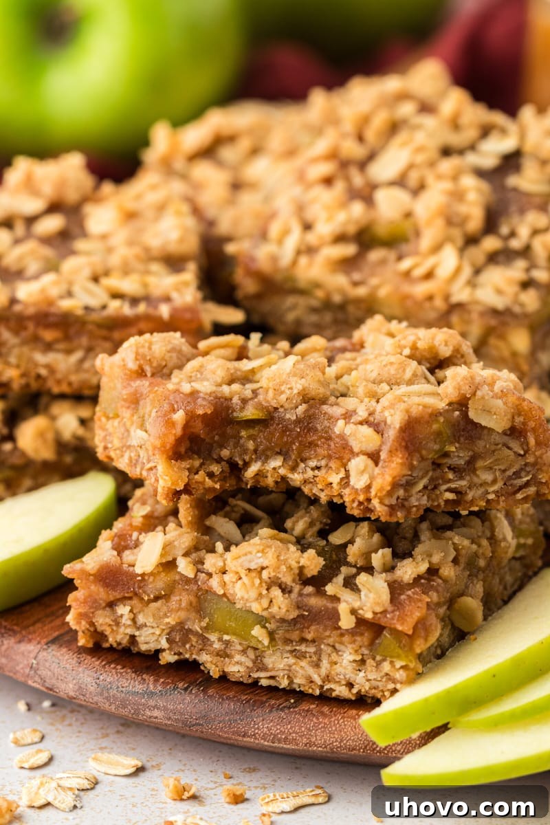 Caramel apple bars stacked on wood cutting board