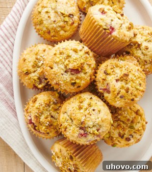 Overhead view of Raspberry Pistachio Muffins on a white oval plate