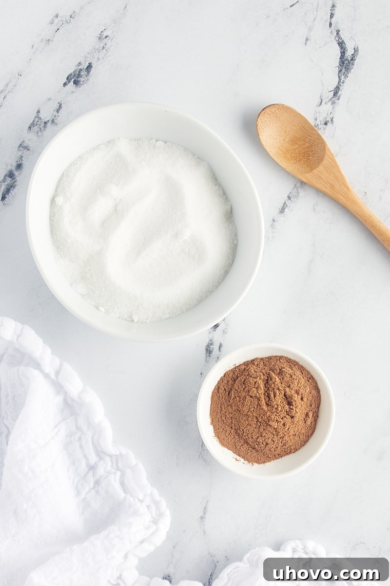 overhead view of sugar and cinnamon in white bowls