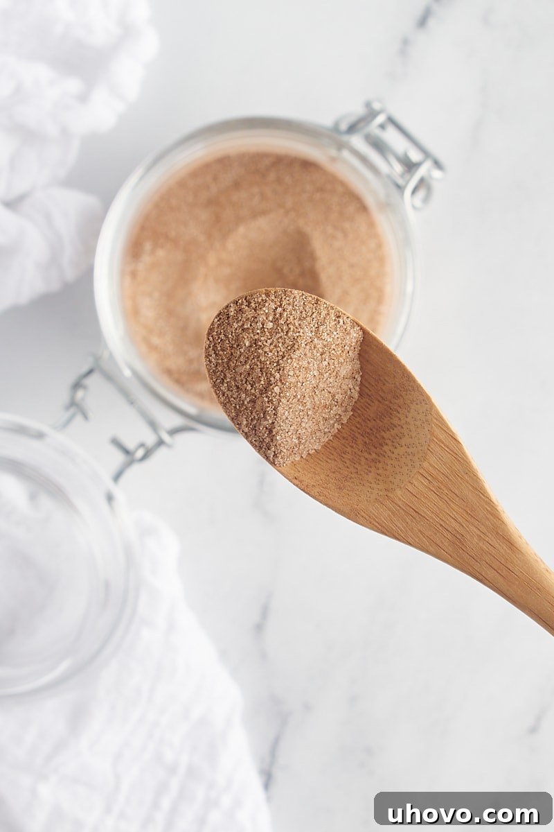 overhead view of cinnamon sugar on a small wooden spoon