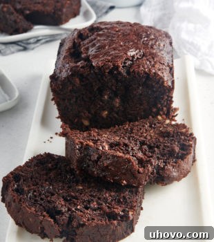 partially sliced Chocolate Zucchini Bread on a white tray