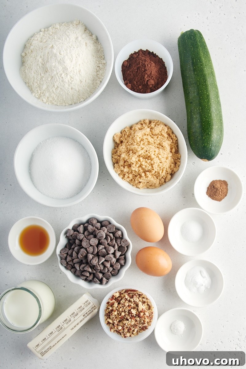 An overhead view displaying all the measured ingredients for Chocolate Zucchini Bread laid out neatly on a surface.