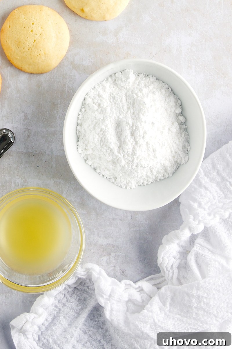 Overhead view of confectioners' sugar and pineapple juice in a small bowl, side-by-side before being mixed into a smooth glaze