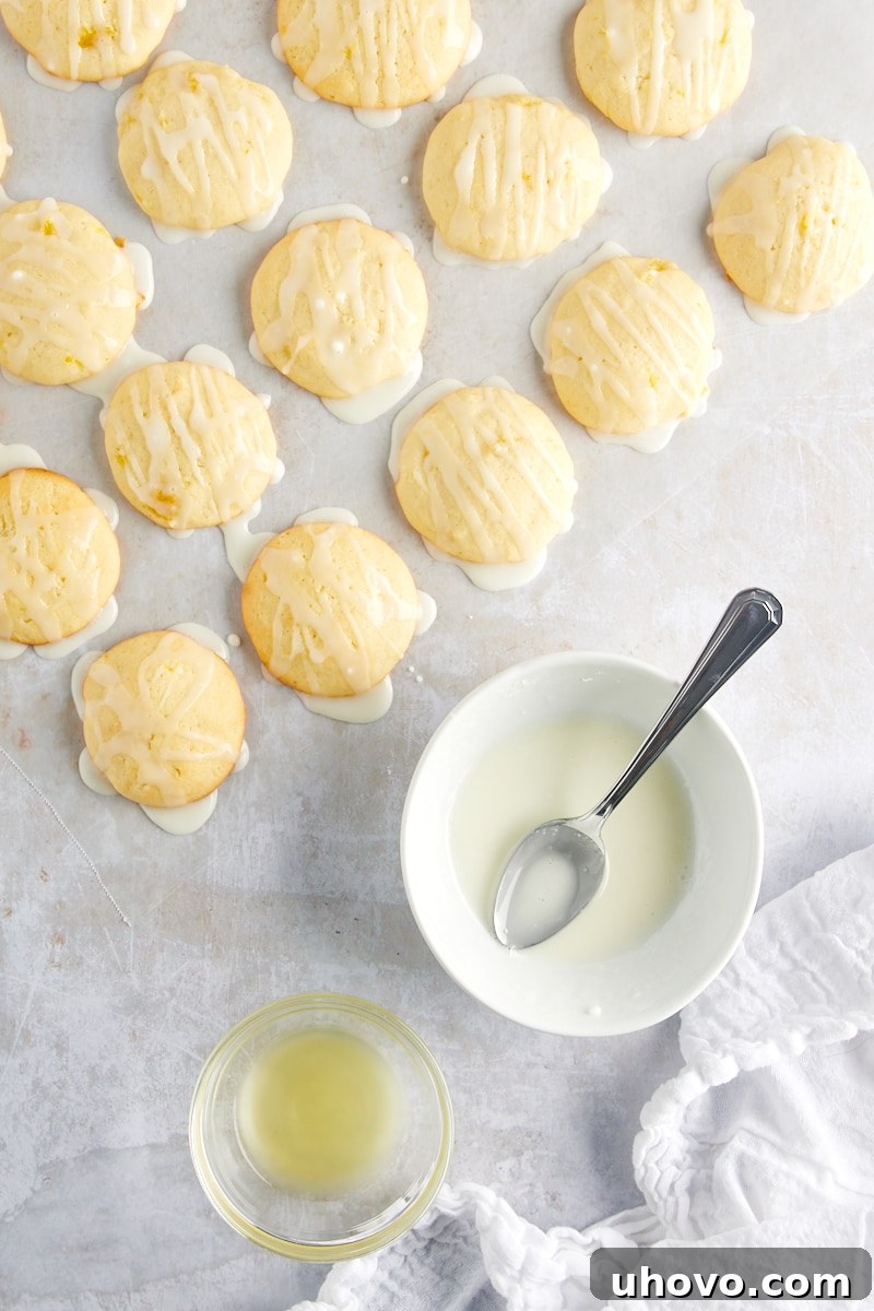 Overhead view of Pineapple Cream Cheese Cookies being artfully drizzled with a sweet glaze, creating an appetizing finish