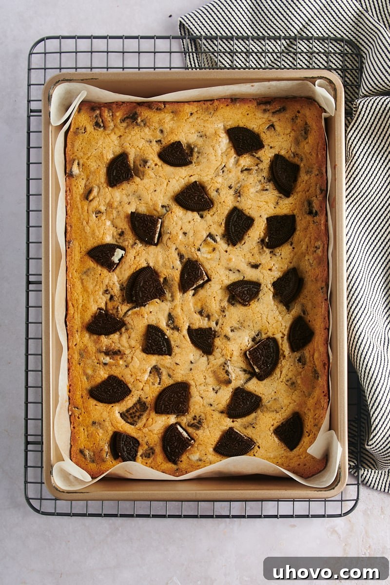 Overhead view of freshly baked Cookies and Cream Blondies cooling in their 9" x 13" baking pan on a wire rack.