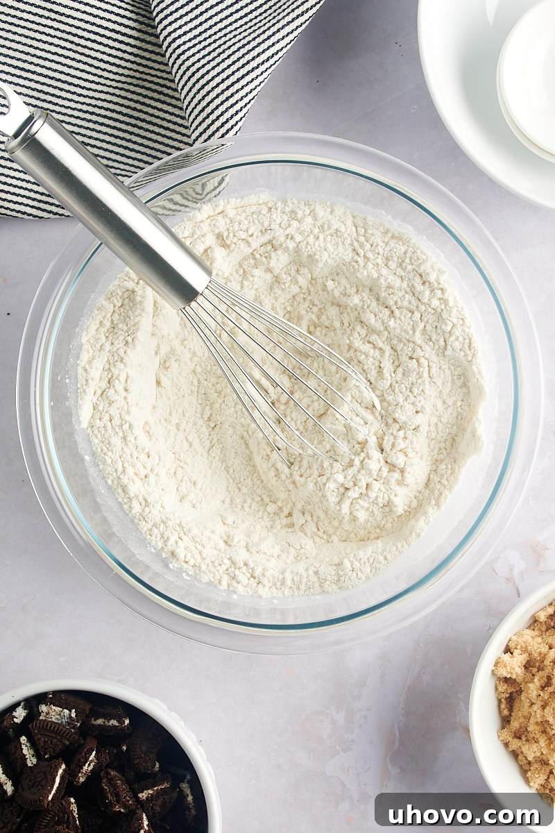 Overhead view of the thoroughly mixed dry ingredients for Cookies and Cream Blondies in a glass bowl.