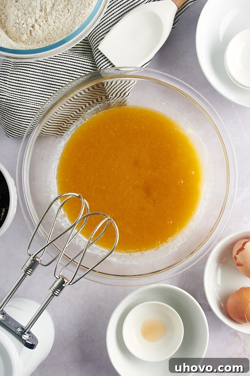 Overhead view of the well-mixed wet ingredients for Cookies and Cream Blondies, creating a smooth, rich batter base.