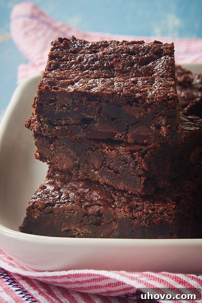 Stack of rich, dark, fudgy Amy's Brownies on a elegant white tray