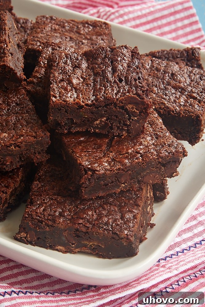 A pristine white tray brimming with freshly baked and cooled Amy's Brownies, ready to be enjoyed