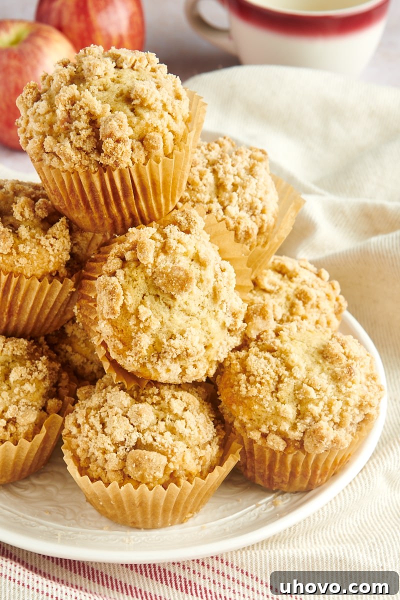 Apple Cinnamon Muffins piled on a white plate