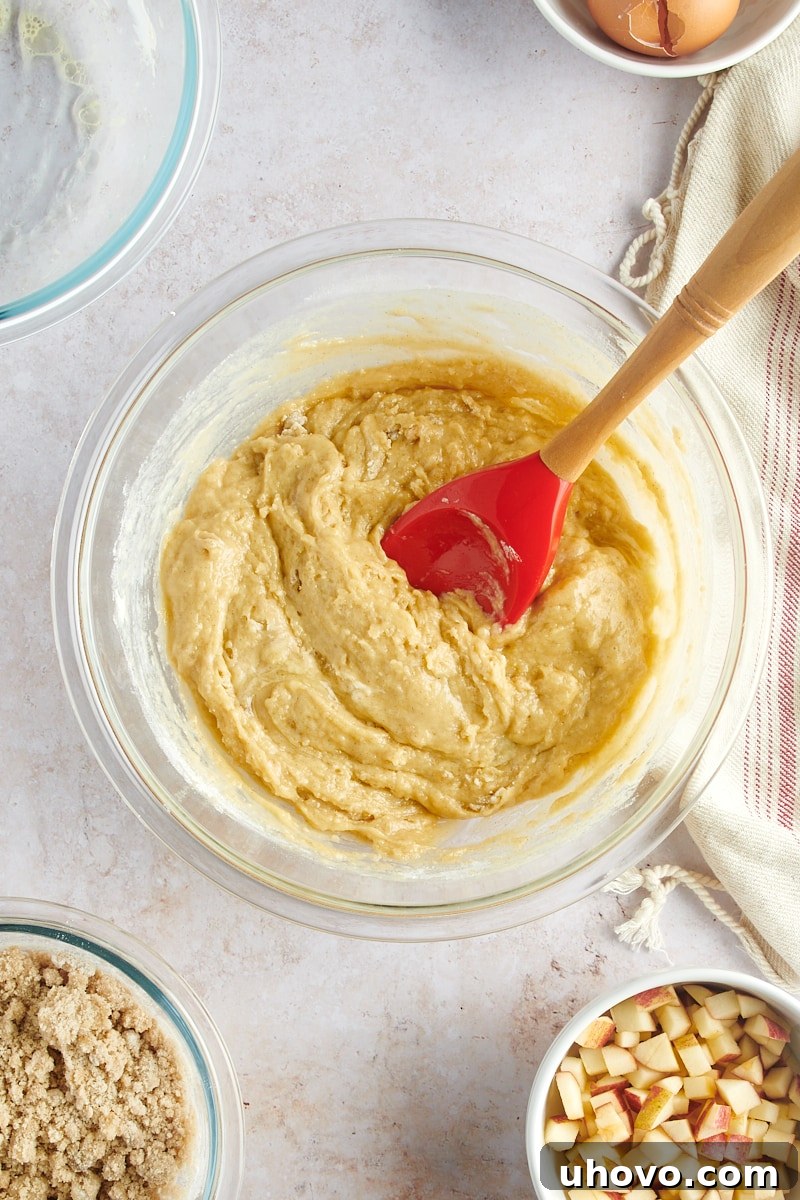 overhead view of mixed muffin batter in a glass mixing bowl