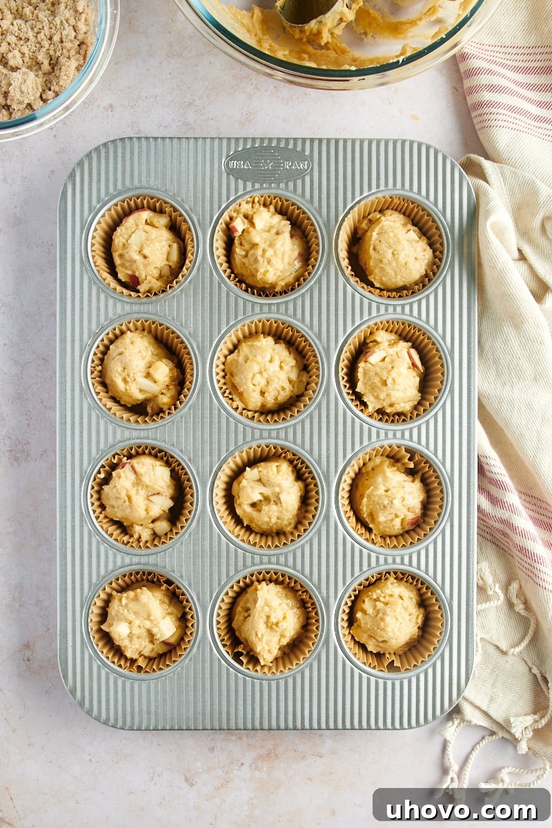 overhead view of Apple Cinnamon Muffin batter in a 12-cup muffin pan