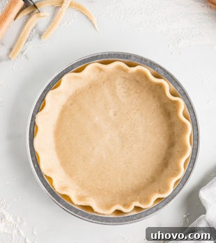 Pie crust in pie plate, showcasing its readiness for any delicious filling. This image highlights the versatility and beauty of a homemade crust.