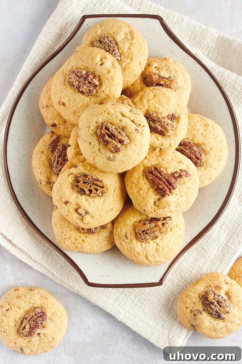 Overhead view of perfectly baked Maple Pecan Cookies arranged on a white and brown-speckled plate, ready for serving.