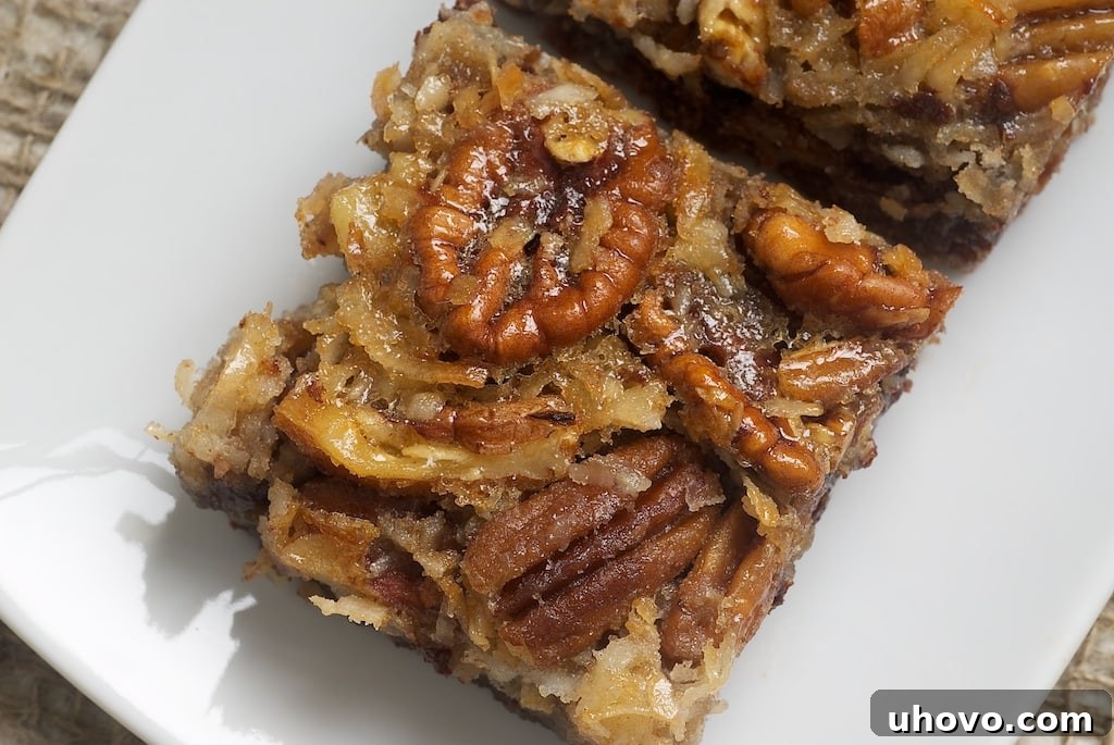 Multiple German Chocolate Pecan Pie Bars arranged on a serving plate, ready to be enjoyed.