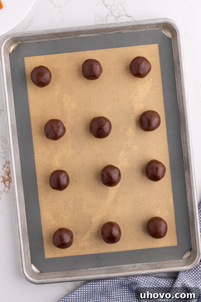 Overhead view of chocolate caramel cookies on baking sheet before baking
