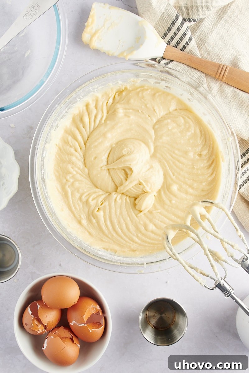 overhead view of mixed Marble Bundt Cake batter in a glass mixing bowl, showing a smooth consistency