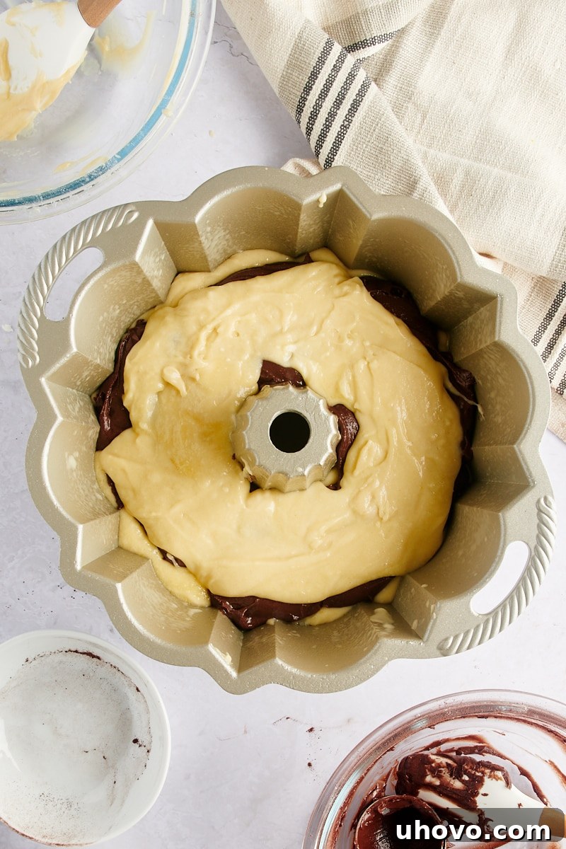 overhead view of three distinct layers of Marble Bundt Cake batter in a Bundt pan