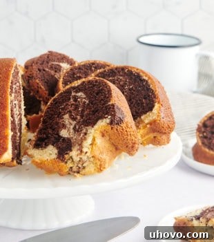 sliced Marble Bundt Cake on a white cake stand