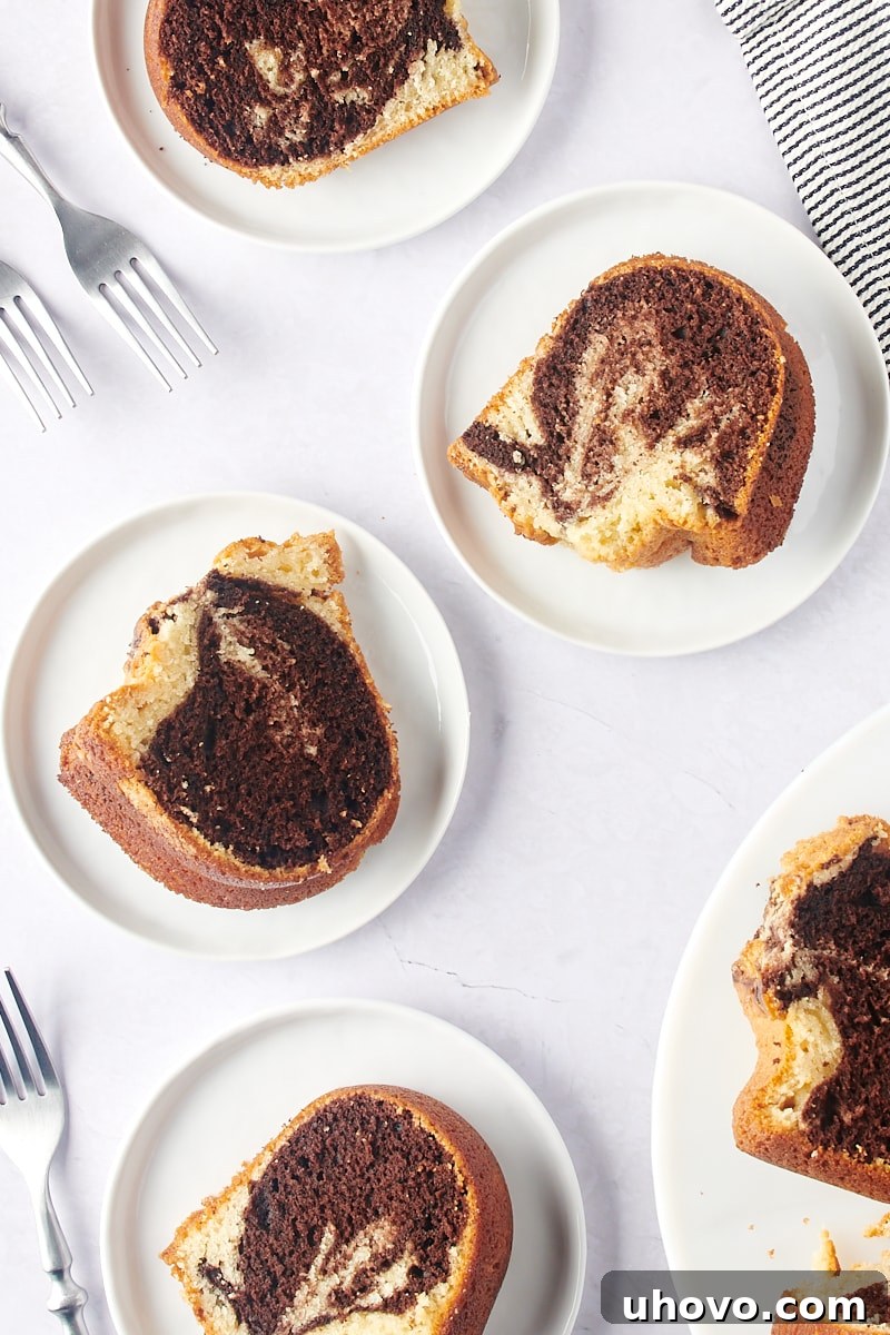 overhead view of slices of Marble Bundt Cake on white plates, ready to be served