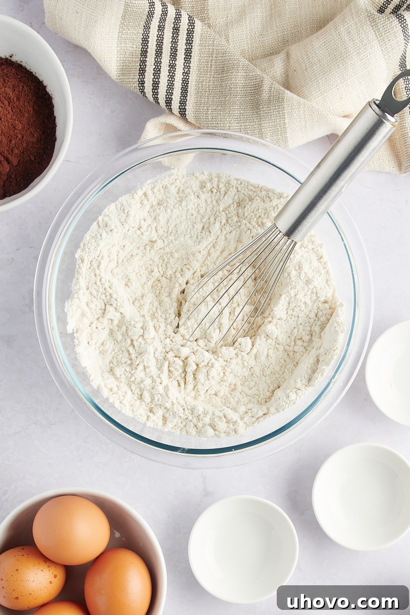 overhead view of mixed dry ingredients for Marble Bundt Cake in a glass bowl