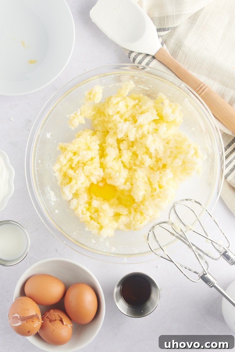 overhead view of an egg being added to the Marble Bundt Cake batter
