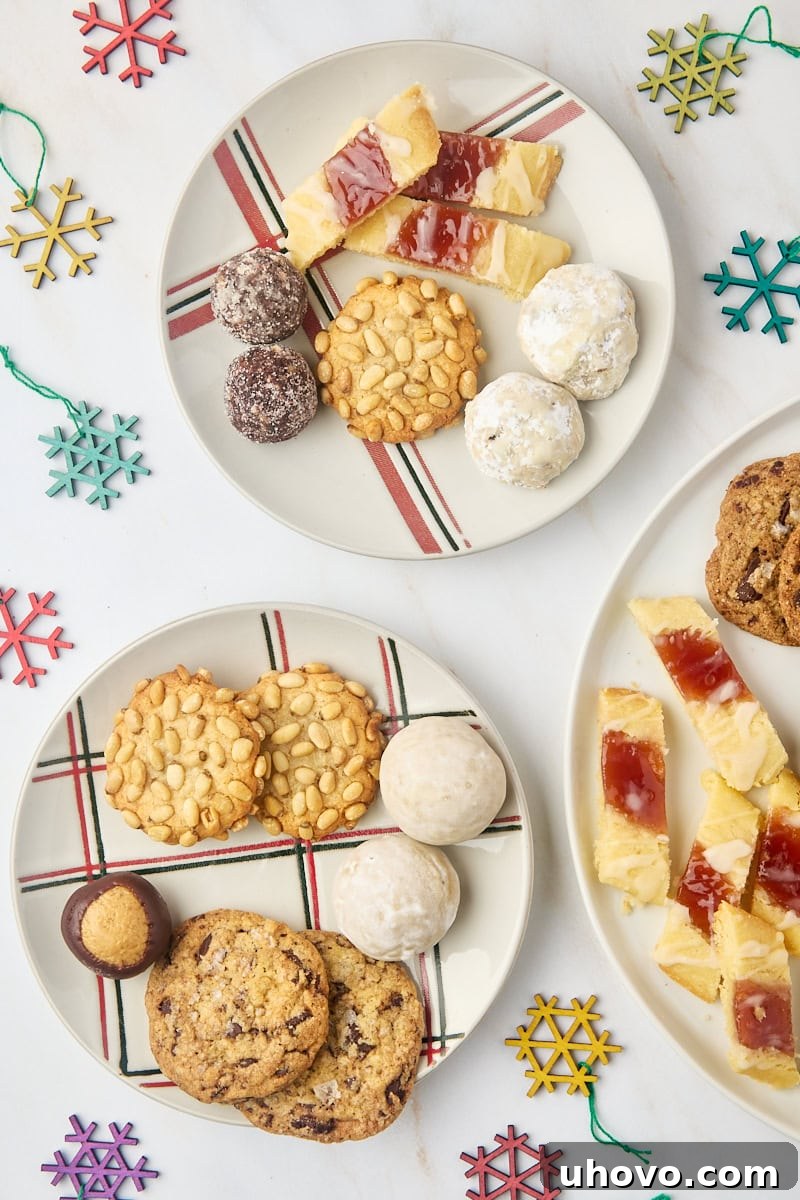 An inviting overhead view of various Christmas cookies and sweet treats artfully arranged on two small plates, ready for holiday enjoyment.