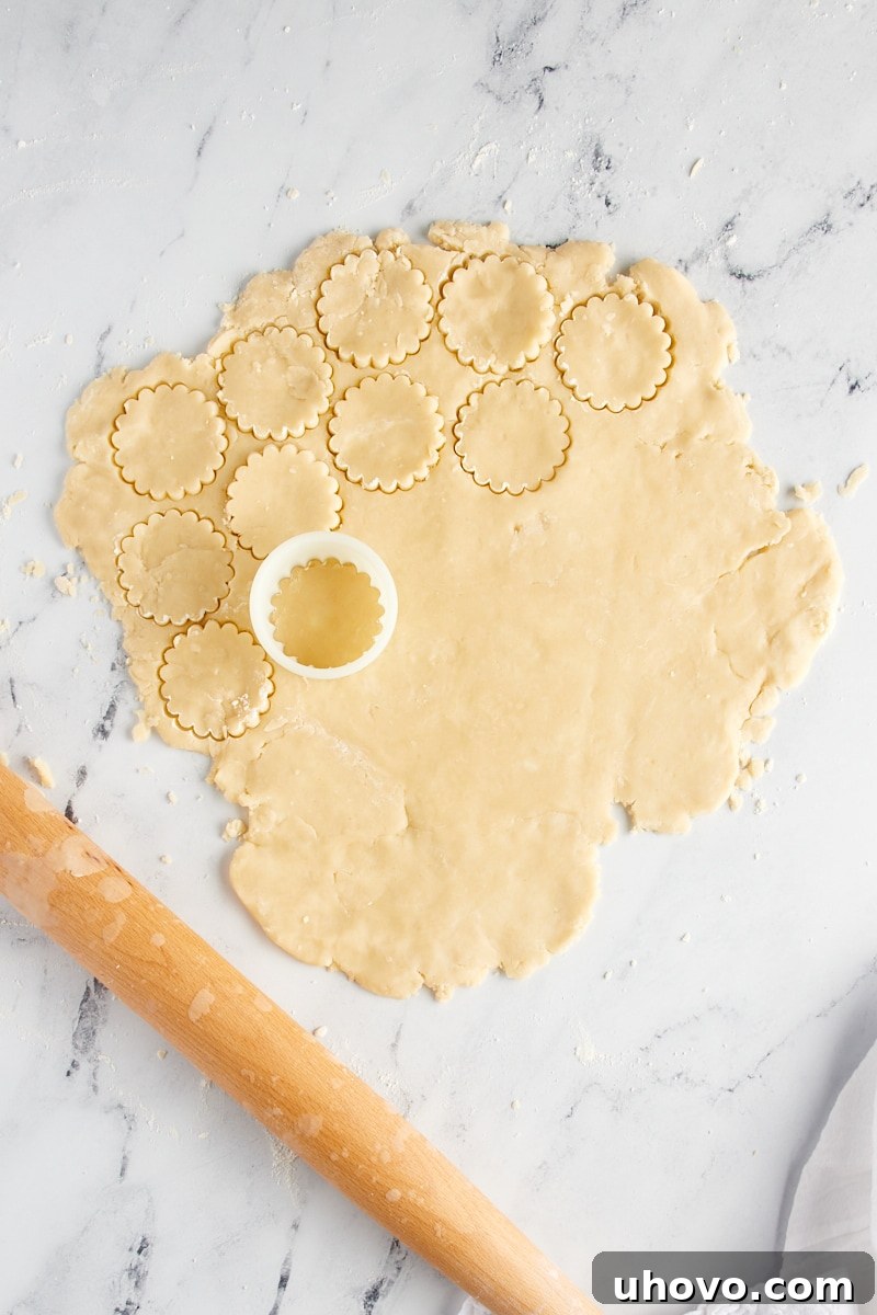 Shortbread cookie dough partially cut with a round cookie cutter.