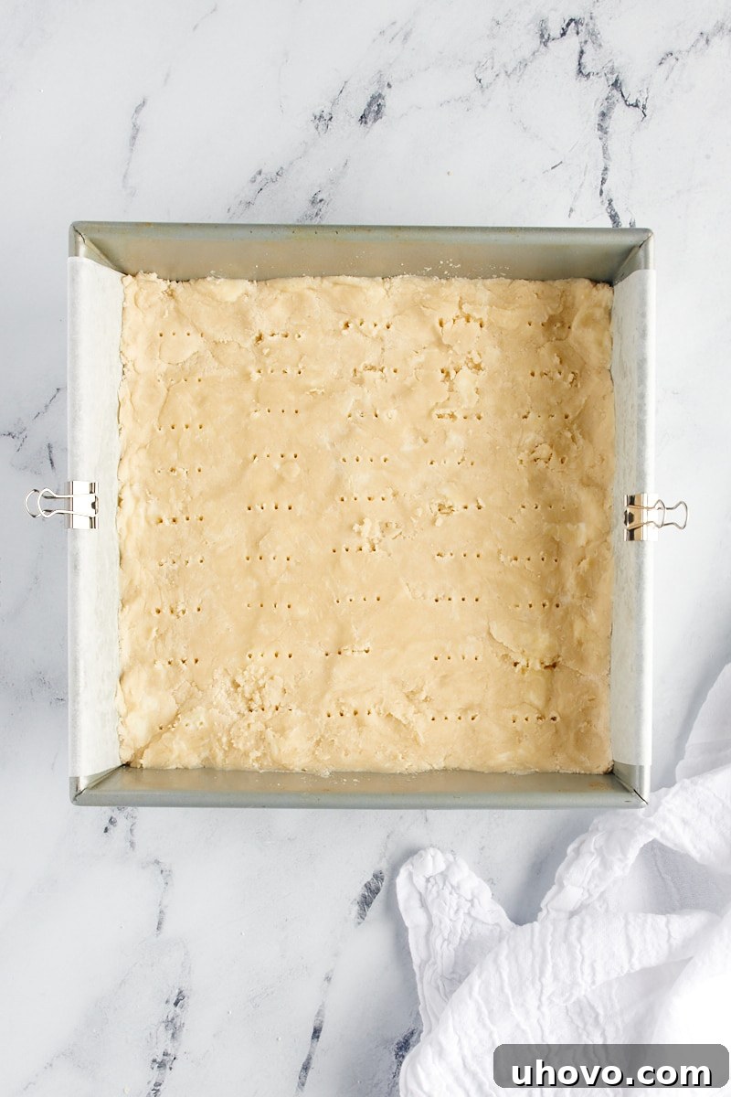 Overhead view of shortbread cookie dough with fork marks over the surface.