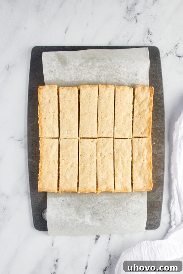 Overhead view of sliced shortbread on a cutting board.