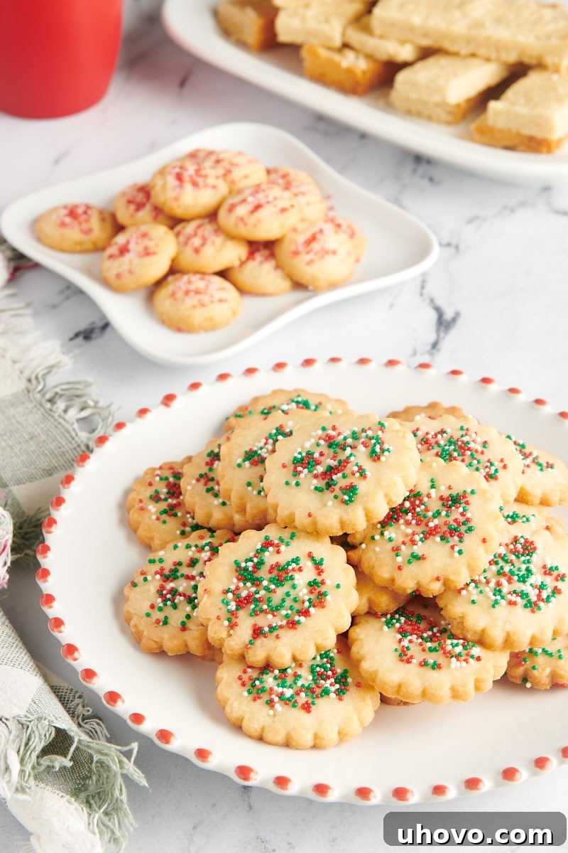 Shortbread cookies arranged on three white plates.