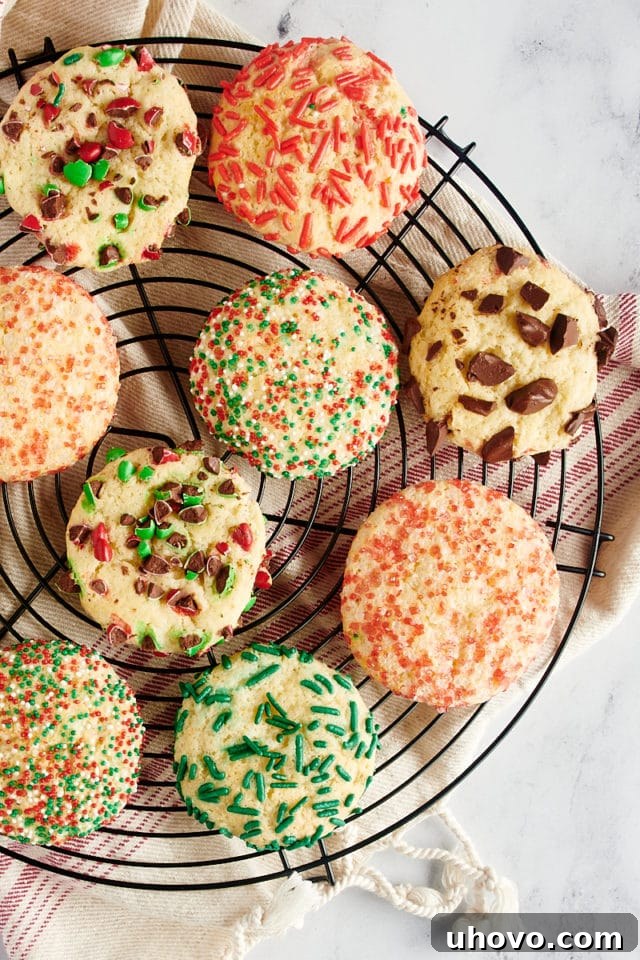 Overhead view of differently topped sugar cookies on a wire rack.