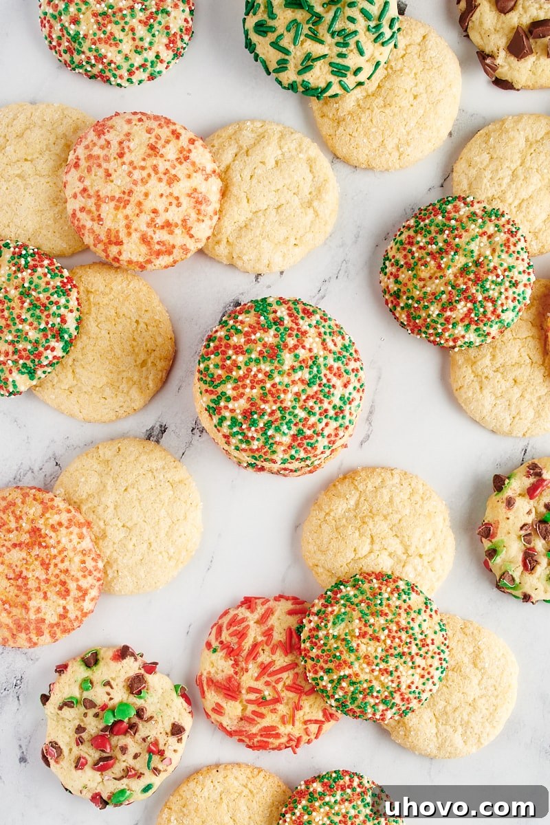 Various sugar cookies scattered over a marble surface.