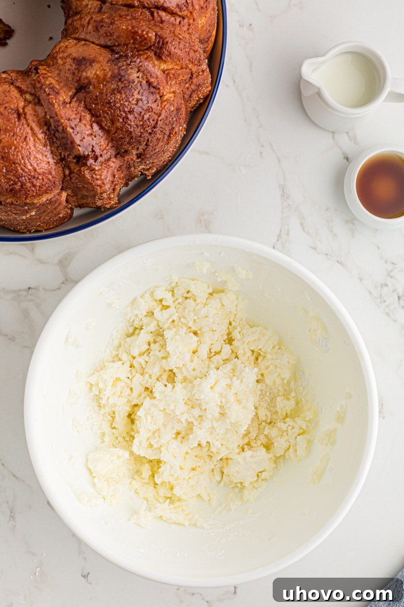 overhead view of mixed cream cheese and confectioners' sugar in a white mixing bowl