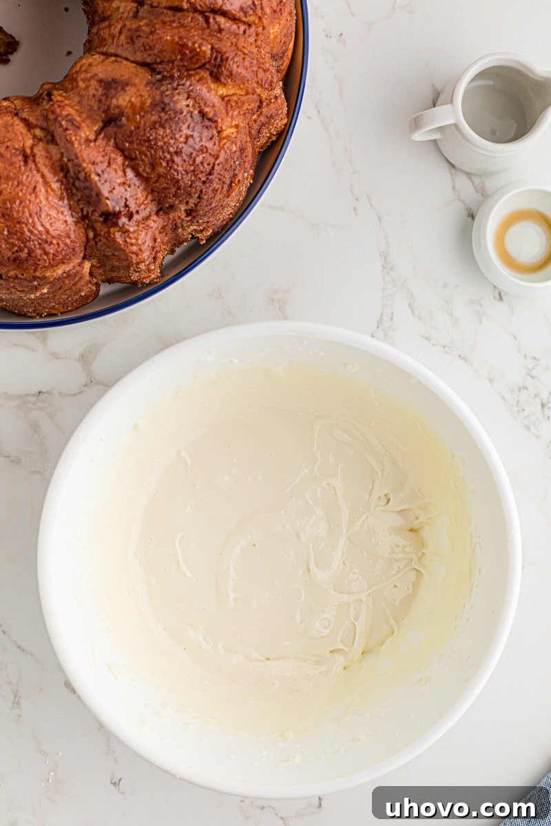 overhead view of cream cheese icing in a white mixing bowl