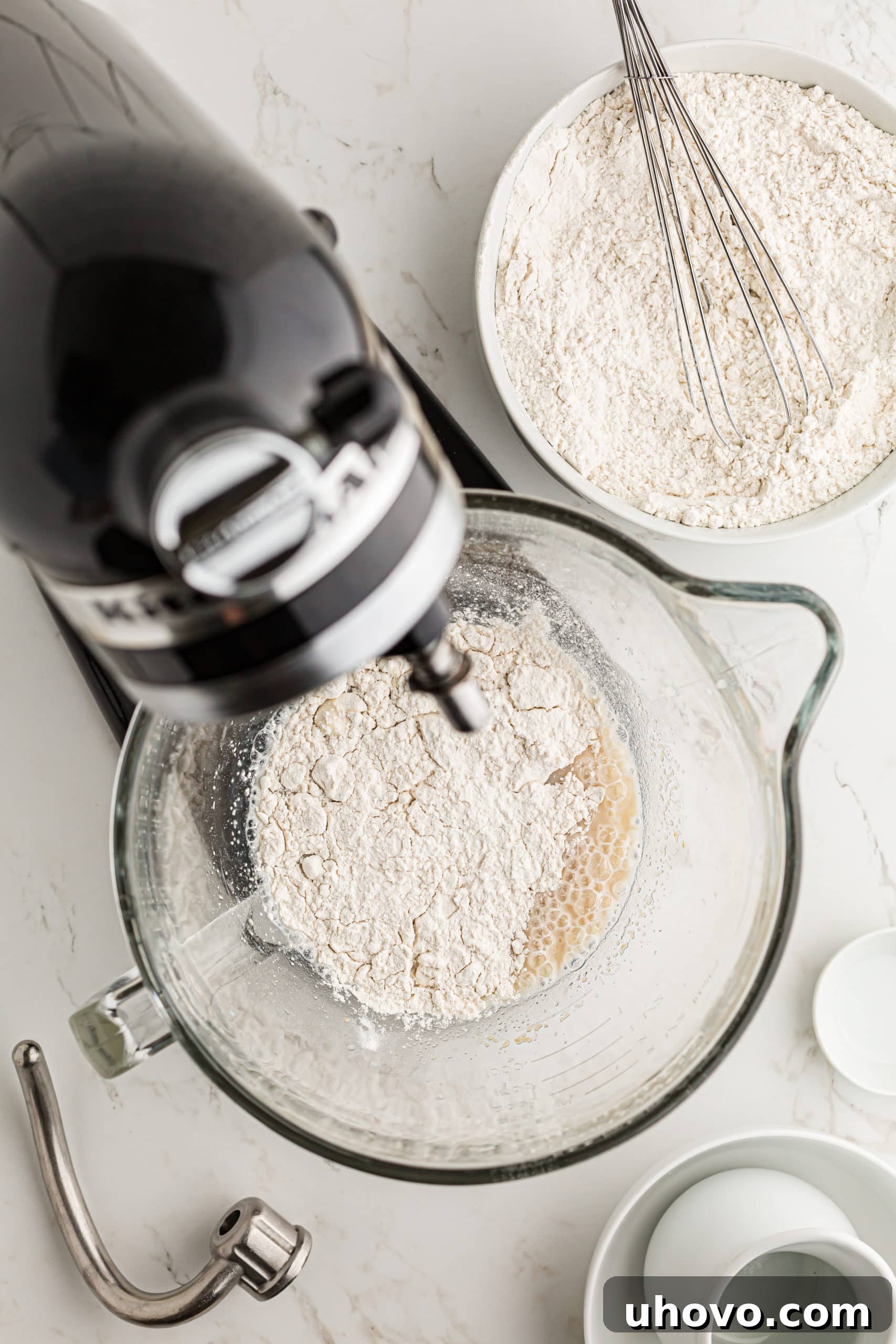 overhead view of flour mixture added to wet ingredients for Monkey Bread