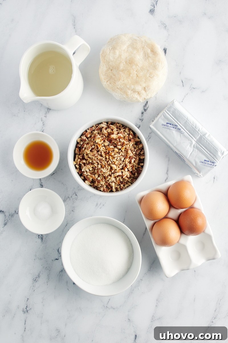 Ingredients for Pecan Cheesecake Pie laid out on a wooden surface.