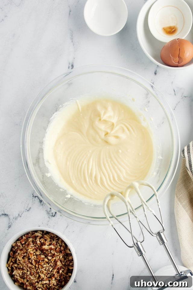 Smooth, creamy cheesecake filling in a glass bowl after mixing.