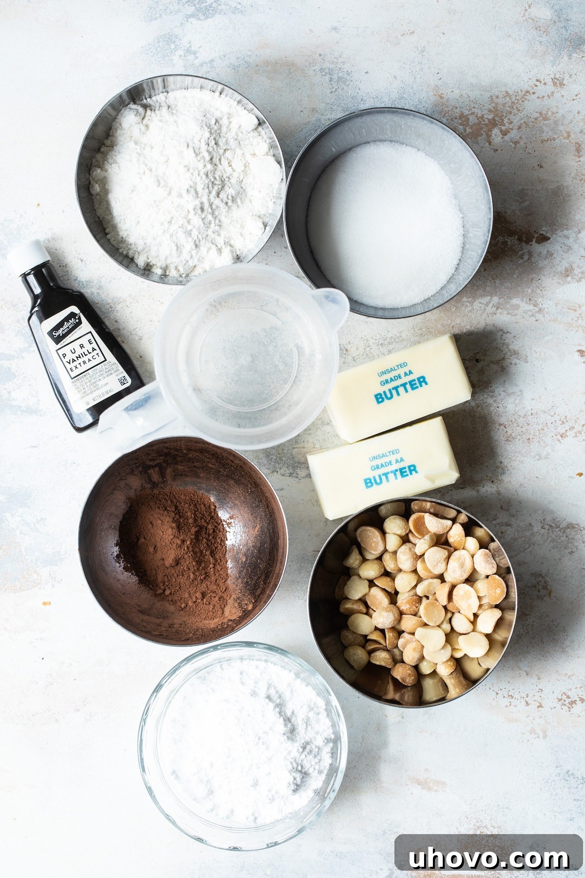 ingredients for cocoa macadamia nut sandies with butter, sugar, flour and nuts