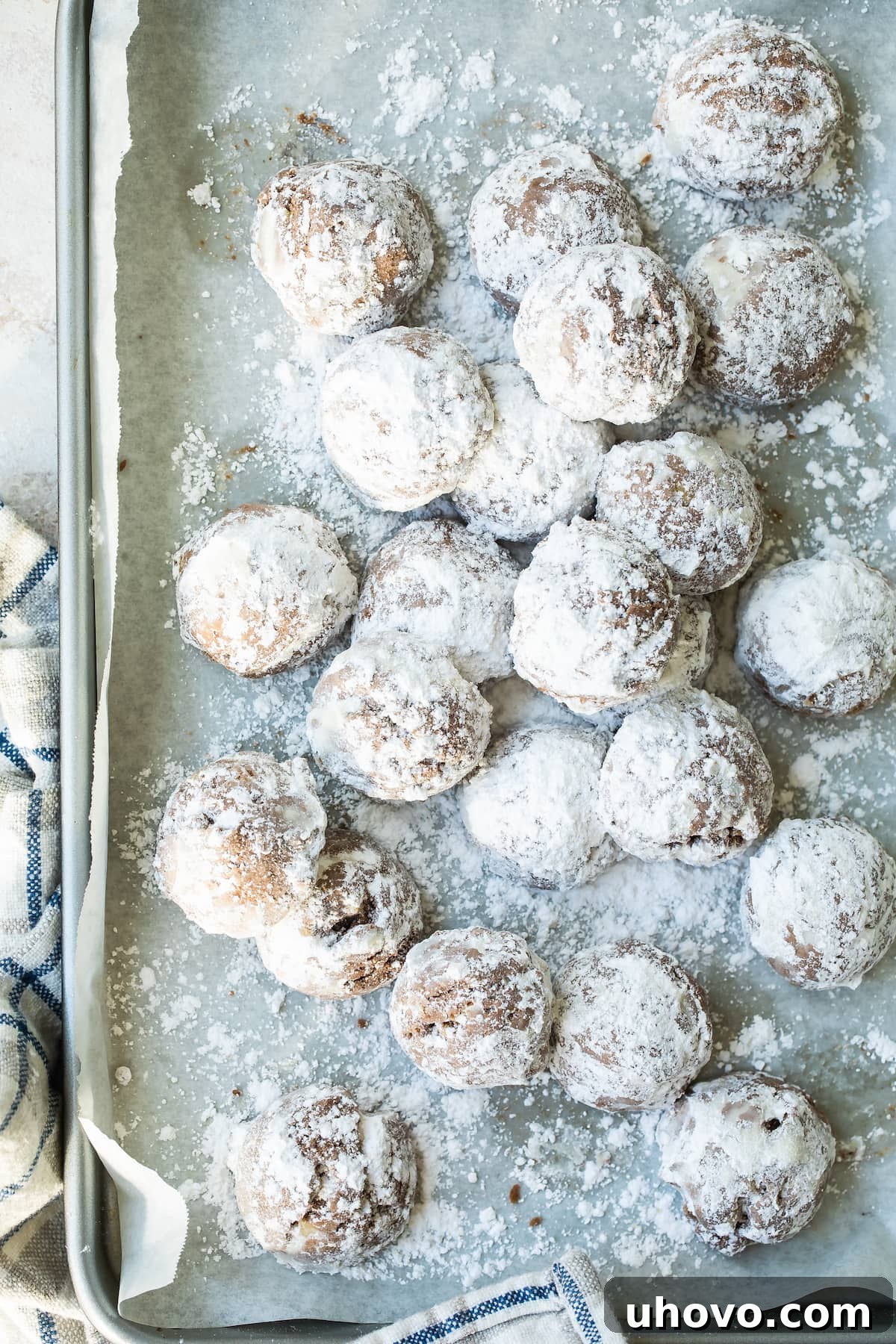 baking sheet of cocoa sandies with powdered sugar
