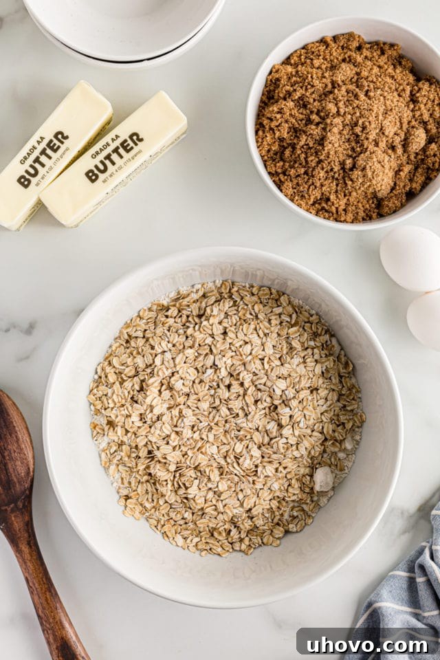 Overhead view of oats, brown sugar, butter, and eggs on countertop