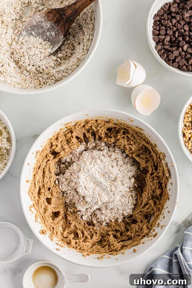 Overhead view of dry ingredients added to cookie dough