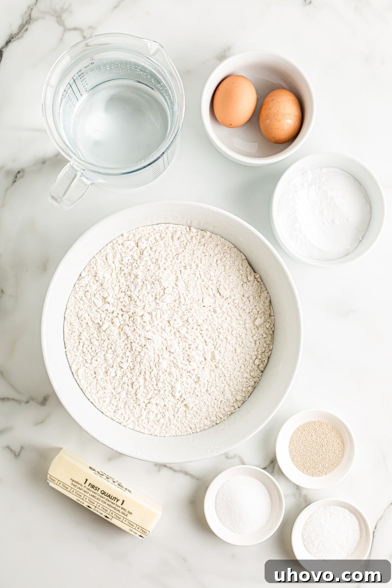 An overhead view of the essential ingredients for homemade pretzel bites laid out on a clean surface, emphasizing simplicity and accessibility.