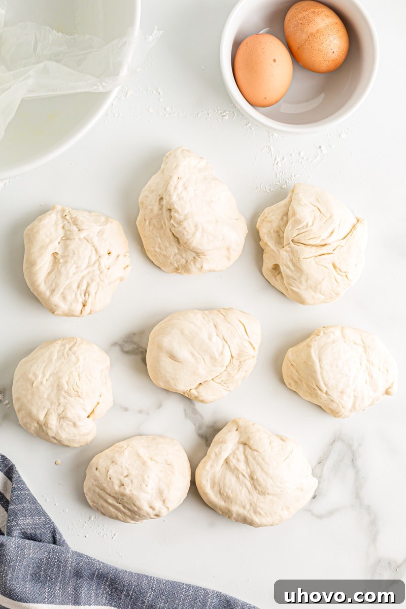 Portioned pretzel dough, rolled into small, manageable balls before stretching.