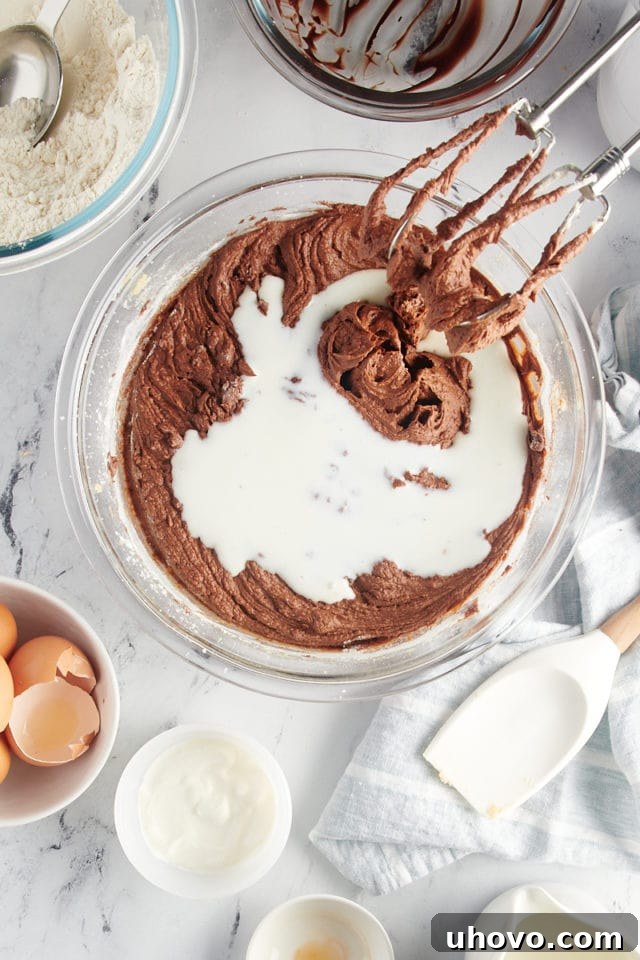 overhead view of buttermilk added to chocolate cake batter