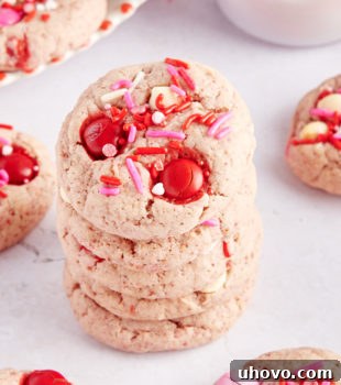 stack of five Strawberry M&M Cookies surrounded by more cookies
