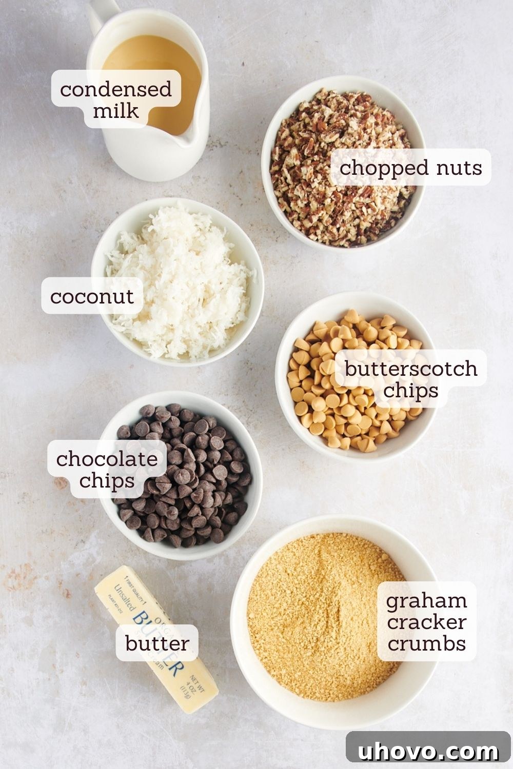 Overhead view of various ingredients for seven layer bars laid out on a surface
